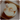 A sliced half on an apple with a flower on it and a white oval Boquet suppository. A metaphor for the female genitals with a suppository in it.