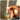 A hand holding a Boquet white oval pill in the bathroom in the sunlight
